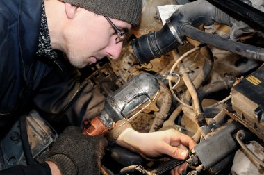 Mechanic repairman at car repair work clipart