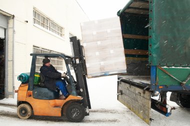 Warehouse forklift loading a car clipart