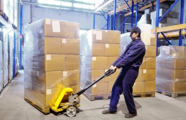 Worker with stacker at warehouse clipart