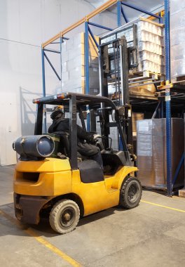 Forklift loader stacking in warehouse clipart