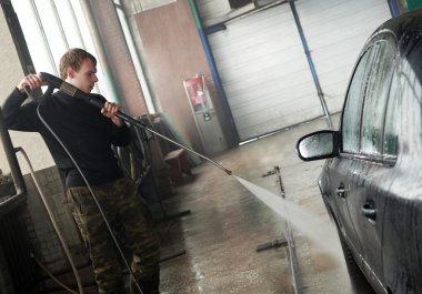 Car cleaning with pressured water clipart