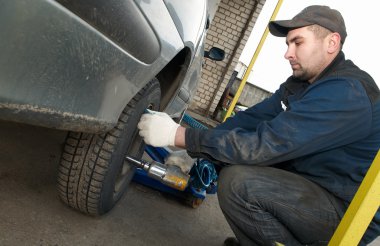 Machanic repairman at tyre replacement clipart