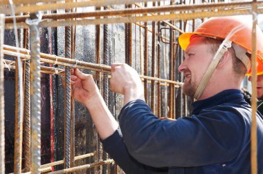 Builder working at construction site clipart