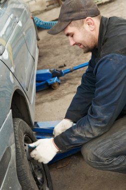 Machanic repairman at tyre replacement clipart
