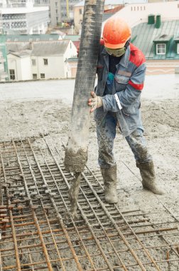 Builder worker pouring concrete into form clipart