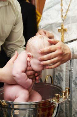 Baby baptism with water in font clipart