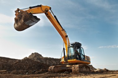 Excavator loader in construction sandpit area clipart