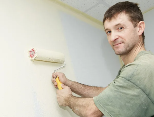 Painter worker with roller at work — Stock Photo, Image