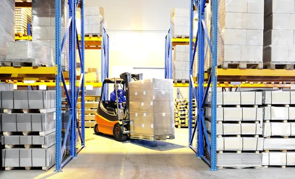 Forklift loader and worker at warehouse — Stock Photo, Image