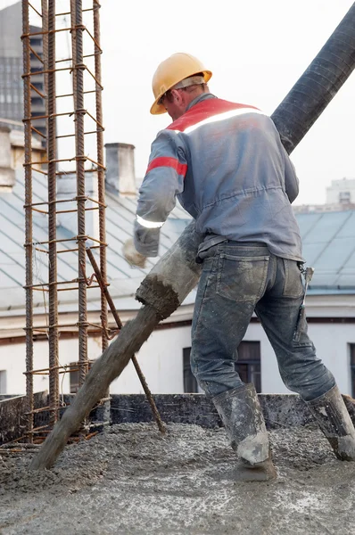 Builder worker pouring concrete into form — Stock Photo, Image