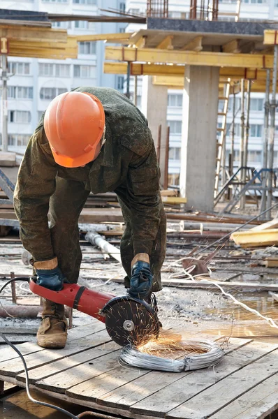 Builder with circular abrasive saw — Stock Photo, Image