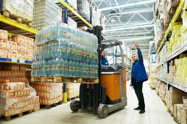 Distribution in warehouse with forklift — Stock Photo, Image