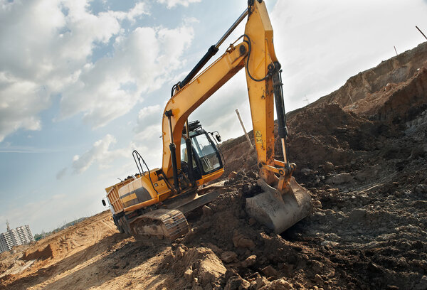 Excavator loader in construction sandpit area