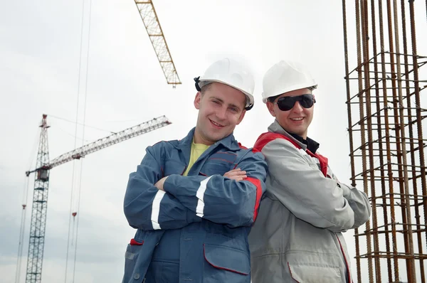Happy builders at construction site — Stock Photo, Image