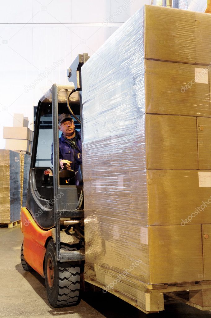 Forklift worker in loader at warehouse