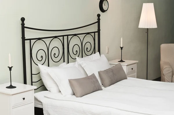 The forged headboard of bed with pillows — Stock Photo, Image