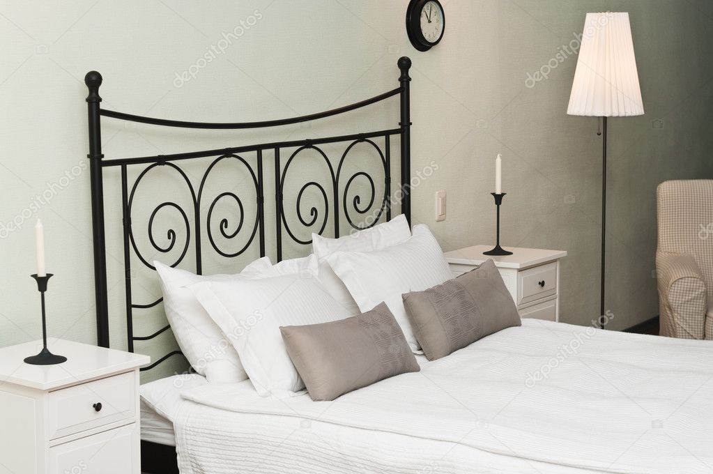 The forged headboard of bed with pillows