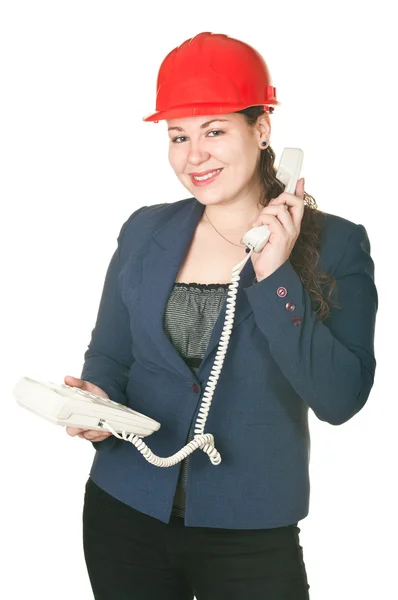 Dziewczyna w czerwonym kasku, rozmowa przez telefon. — Zdjęcie stockowe