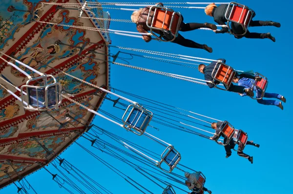 Action photo of carousel on blue sky — Stock Photo, Image