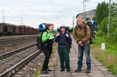 Group of travelers on railway station waiting a train. Mountaineering with clipart