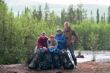 Group of travelers trekking in forest Mountaineering with knapsacks clipart