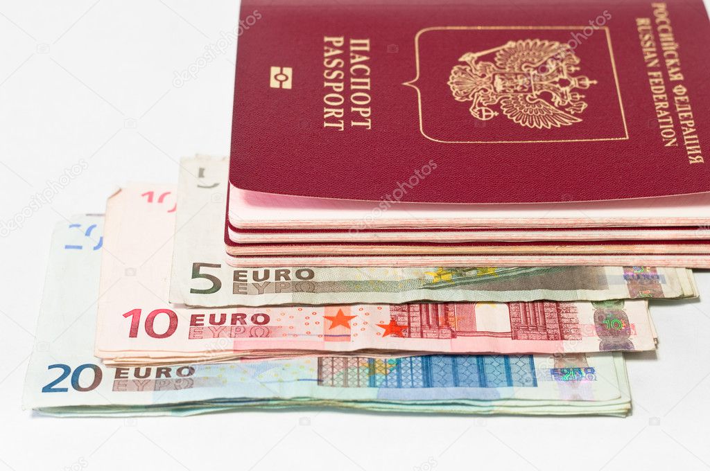 Pile of red passports and euro cash small banknotes on white