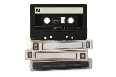 Audio cassette on three boxes isolated on white background clipart