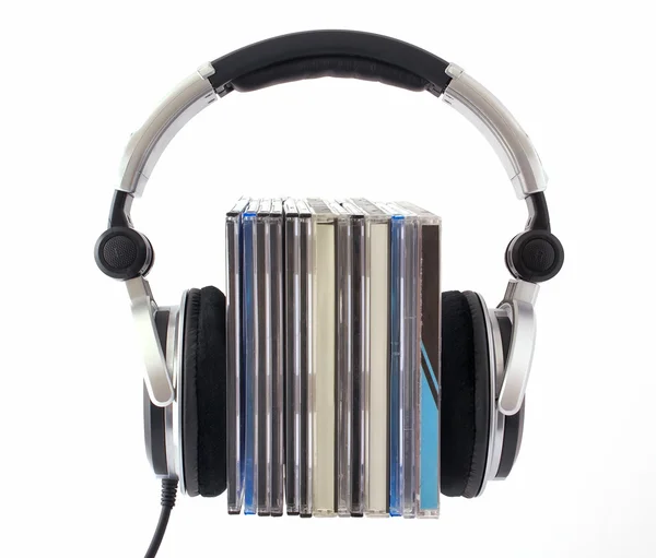Headphones with CD boxes on white background — Stock Photo, Image