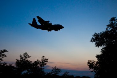 Silhouette of Lockheed C-130 Hercules at Dusk clipart