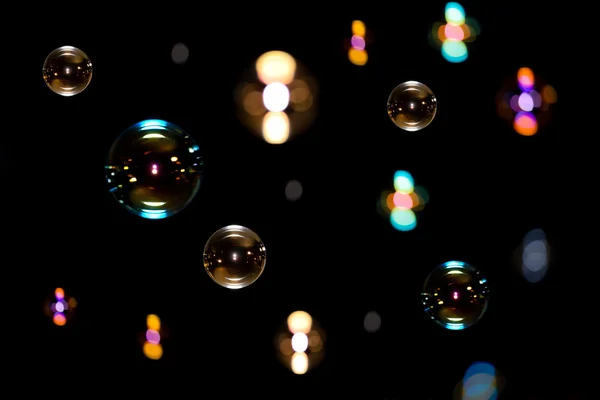 Мыльные пузыри на черном фоне — стоковое фото