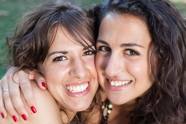 Two girls hugging themselves tightly — Stock Photo, Image