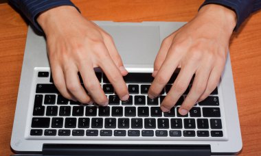 Man Hand Typing on Computer Keyboard clipart