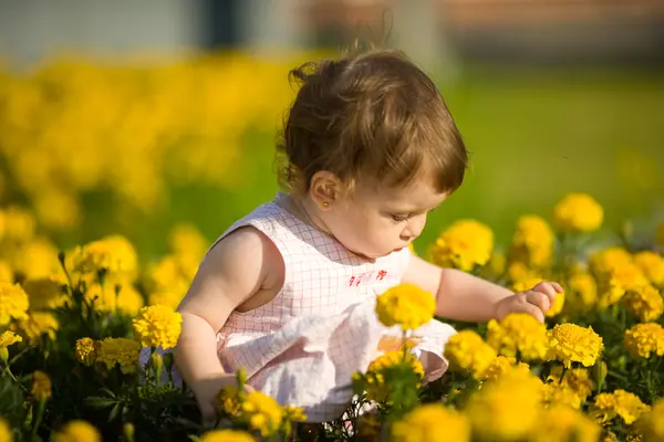 Liten flicka i blommor — Stockfoto