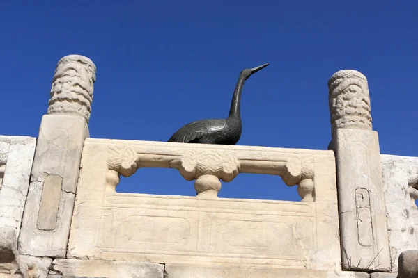 stock image Statue of crane behind wall