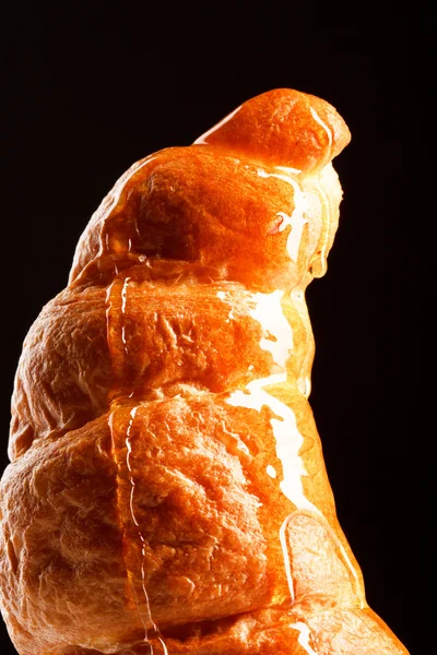 Fresh croissant with honey — Stock Photo, Image