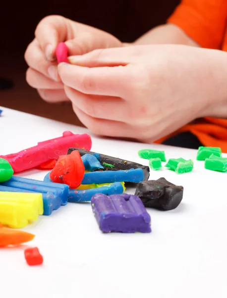 stock image Boy moulds from plasticine on table