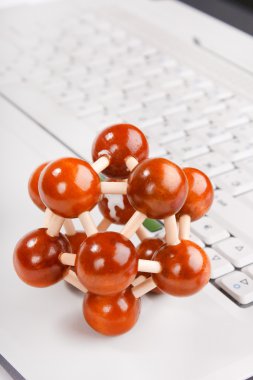 Laptop with model of molecule clipart