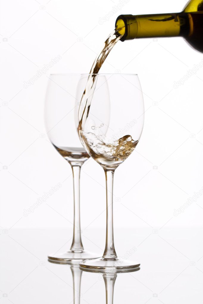 White wine pouring down from a wine bottle