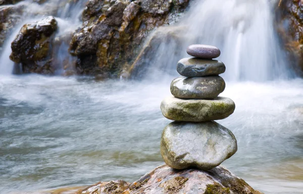 Pebble stones over waterfall — Stock Photo, Image