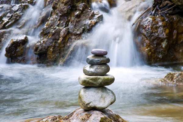 Pebble stones over waterfall Stock Picture