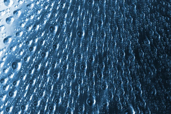 Bulles d'eau sur un verre bleu — Photo