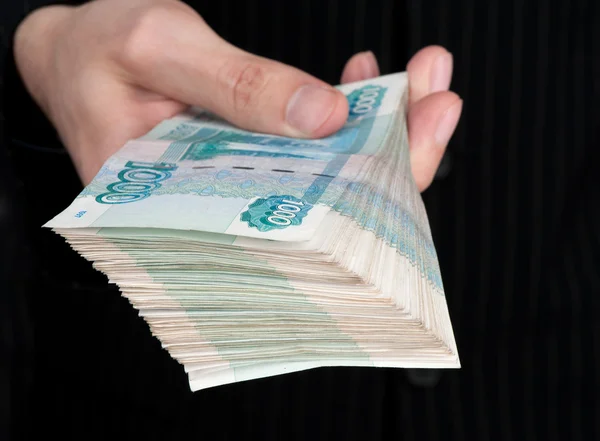 Hand holding boundle of roubles — Stock Photo, Image