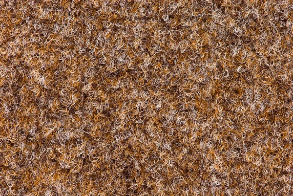 Textuur van tapijt dekking van bruine kleur met een ondiepe nap — Stockfoto