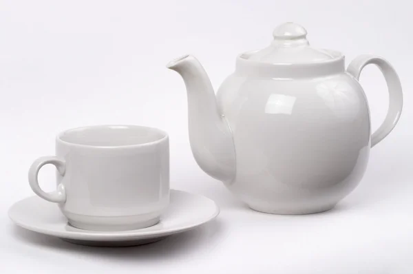 Little white tea cup and a kettle — Stock Photo, Image