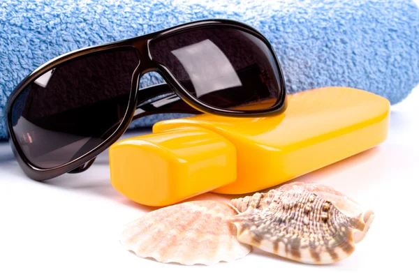 stock image Towel, shells, sunglasses and lotion