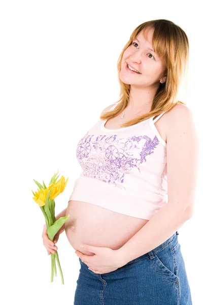 Těhotná žena s žluté tulipány — Stock fotografie