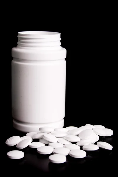 Frasco con pastillas blancas — Foto de Stock