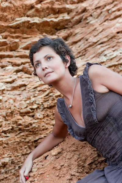 Attractive brunet woman among rocks — Stock Photo, Image