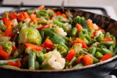 Vegetables on a frying pan. clipart