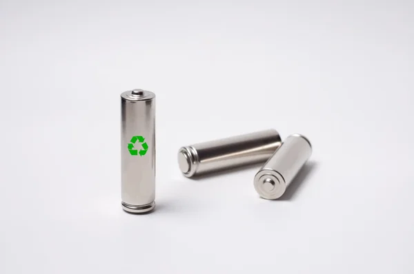 Três baterias com um símbolo . — Fotografia de Stock